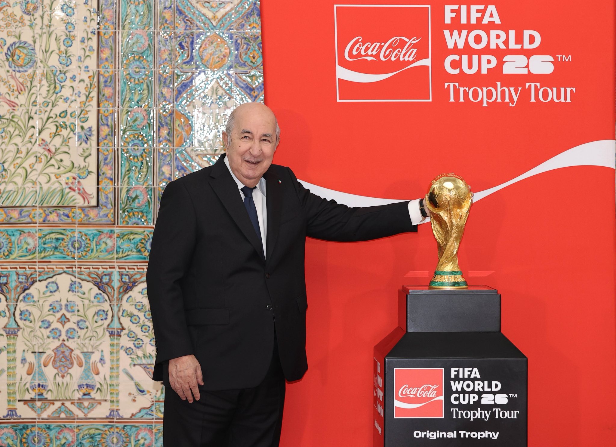 It could be an image of football, football and contain the text 'CocaCola FIFA WORLD CUP CUP26 26 TM Trophy Tour ् FIFA CocaCola WORLD CUP 20 25M TM Trophy Tour Original Trophy'