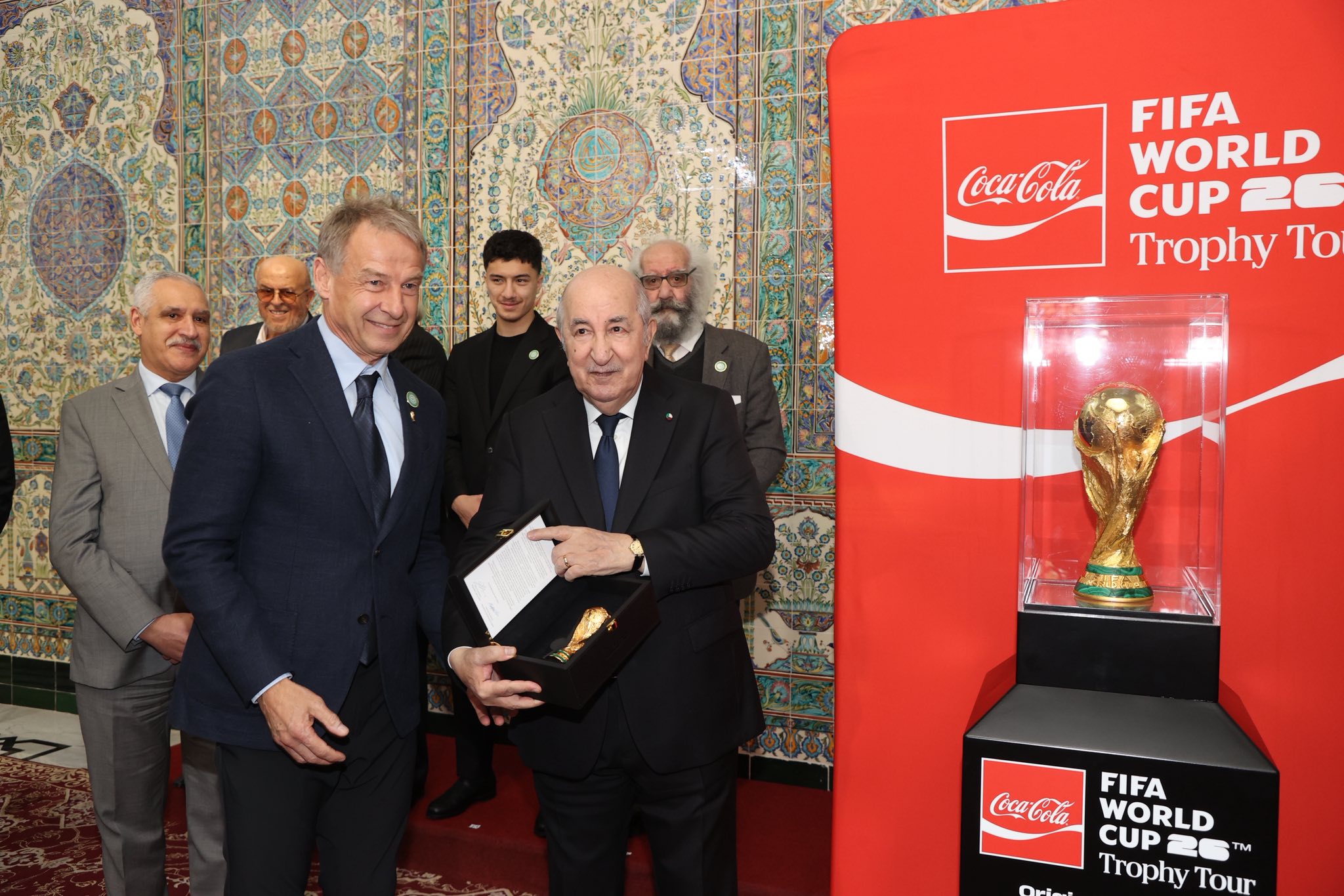 It could be an image of football, football and contain the text 'CocaCola oola FIFA WORLD CUP CUP26 26 Trophy To ស 原売果液 FIFA Coca-Cola WORLD CUP20 T CUP Trophy Tour'